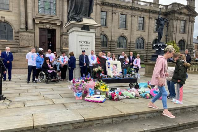 Numerous bunches of flowers and wreaths were laid at the Chloe and Liam memorial bench.