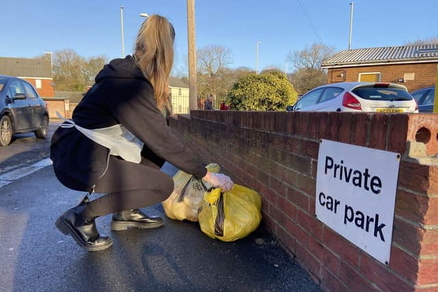 The bags of waste which have been illegally dumped being collected from outside the nursery's car park. 

Picture by FRANK REID