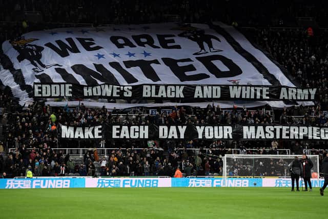 A banner displayed by fans reads "Eddie Howe's Black and White Army" ahead of the English Premier League football match between Newcastle United and Norwich City at St James' Park in Newcastle-upon-Tyne, north east England on November 30, 2021.(Photo by Oli SCARFF / AFP)