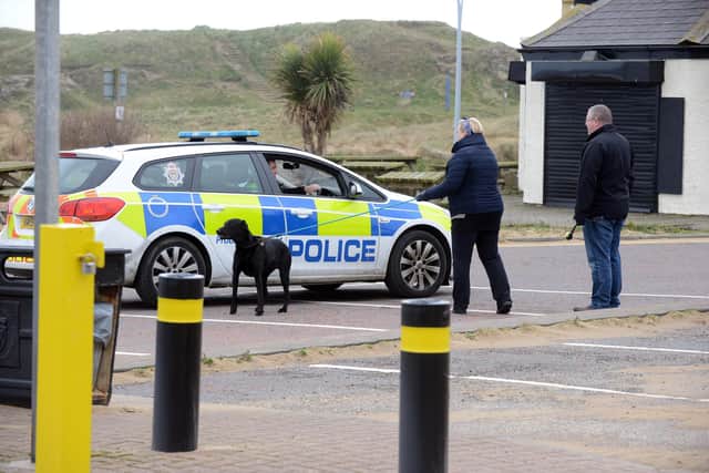 Police officers speaking to dog walkers at Sandhaven Beach in South Shields.