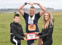 John was awarded a certificate for finishing the Great North Run at South Shields by his children William and Robyn.