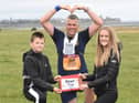 John was awarded a certificate for finishing the Great North Run at South Shields by his children William and Robyn.