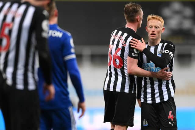 NEWCASTLE UPON TYNE, ENGLAND - JANUARY 03: Matthew Longstaff (r) of Newcastle United is consoled by brother Sean Longstaff after the Premier League match between Newcastle United and Leicester City at St. James Park on January 03, 2021 in Newcastle upon Tyne, England. The match will be played without fans, behind closed doors as a Covid-19 precaution. (Photo by Stu Forster/Getty Images)