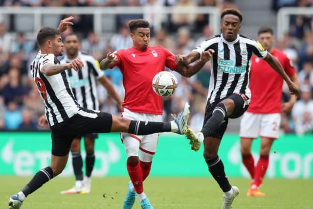 Jesse Lingard of Nottingham Forest is challenged by Bruno Guimaraes and Joe Willock of Newcastle United during the Premier League match between Newcastle United and Nottingham Forest at St. James Park on August 06, 2022 in Newcastle upon Tyne, England. (Photo by Jan Kruger/Getty Images)