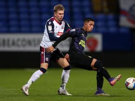 Rodrigo Vilca of Newcastle United U21's on the ball with Jak Hickman of Bolton Wanderers during the EFL Trophy match between Bolton Wanderers and Newcastle United U21 at University of Bolton Stadium on November 17, 2020 in Bolton, England. Sporting stadiums around the UK remain under strict restrictions due to the Coronavirus Pandemic as Government social distancing laws prohibit fans inside venues resulting in games being played behind closed doors. (Photo by Charlotte Tattersall/Getty Images)