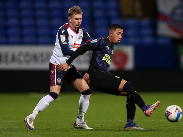 Rodrigo Vilca of Newcastle United U21's on the ball with Jak Hickman of Bolton Wanderers during the EFL Trophy match between Bolton Wanderers and Newcastle United U21 at University of Bolton Stadium on November 17, 2020 in Bolton, England. Sporting stadiums around the UK remain under strict restrictions due to the Coronavirus Pandemic as Government social distancing laws prohibit fans inside venues resulting in games being played behind closed doors. (Photo by Charlotte Tattersall/Getty Images)