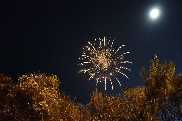 The moon shining just as brightly as the fireworks in a clear Sunday night sky. Picture: Jess Rachael.