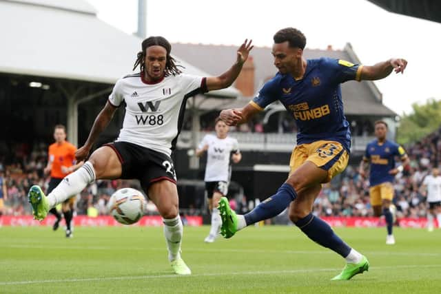 Jacob Murphy of Newcastle United is challenged by Kevin Mbabu of Fulham during the Premier League match between Fulham FC and Newcastle United at Craven Cottage on October 01, 2022 in London, England. (Photo by Henry Browne/Getty Images)