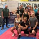 Coaches and gym members celebrate hitting raising £250k for charities through boxing shows and other charity events including the David Goggins 4x4x48 challenge with Chris Goodall (front left).