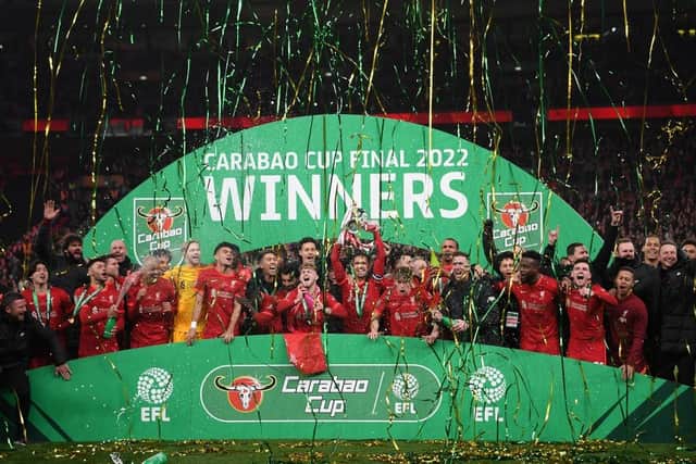 LONDON, ENGLAND - FEBRUARY 27: Jordan Henderson of Liverpool lifts the Carabao Cup trophy following victory in the Carabao Cup Final match between Chelsea and Liverpool at Wembley Stadium on February 27, 2022 in London, England. (Photo by Shaun Botterill/Getty Images)