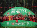 LONDON, ENGLAND - FEBRUARY 27: Jordan Henderson of Liverpool lifts the Carabao Cup trophy following victory in the Carabao Cup Final match between Chelsea and Liverpool at Wembley Stadium on February 27, 2022 in London, England. (Photo by Shaun Botterill/Getty Images)