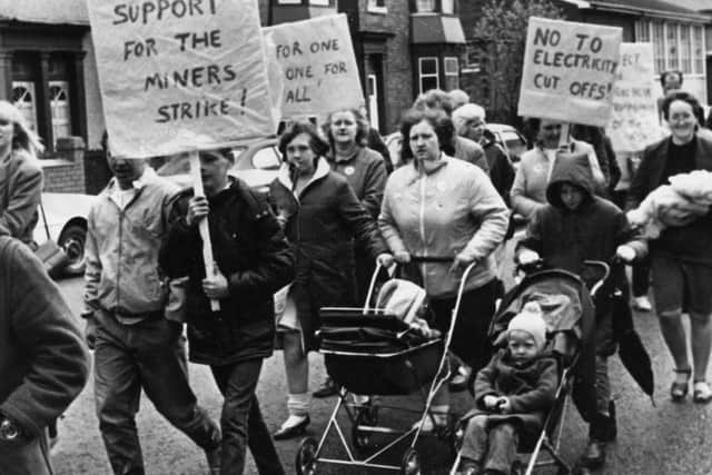 Striking miners and their families stage a protest march to highlight the threat of electricity being cut off at miners' homes because of non-payment of bills, in May 1984