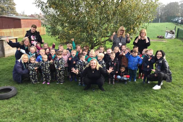 Staff and children celebrate the nursery's outstanding Ofsted judgement. Manager Jenny Parker (centre), (right side) Claudia Pirie, teaching assistant, Jacqui Westhall, teacher and Andrea Howard, administrator, along with (left side) Jess Riley, higher level teaching assistant, Wendy Macdonald and Amy Brady, both teaching assistant.