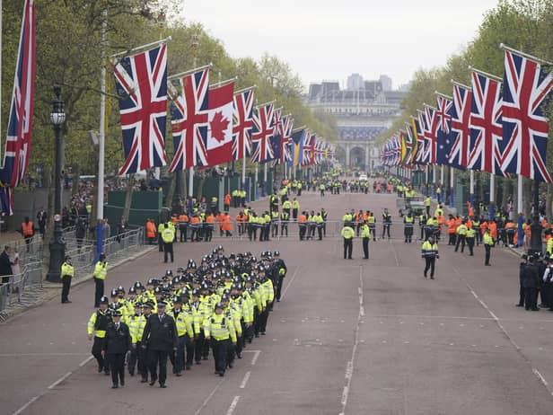 Metropolitan Police officers march along The Mall in London as they head to their positions for of the coronation processions of King Charles III and Queen Camilla.