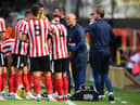 Sunderland boss Alex Neil speaks to his players.