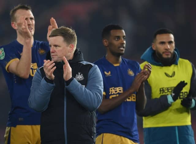 Newcastle United head coach Eddie Howe and some of his players, including Alexander Isak, applaud fans at the end of the game.