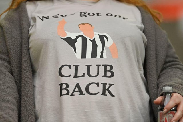 A fan wears a T-shirt celebrating the recent take over of Newcastle United by a Saudi-led consortium ahead of the Spurs match at St James's Park.
