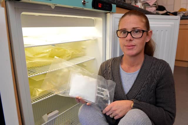 Mother Katy Jones at the additional fridge used to store Hannah's medicines and solution based food.
