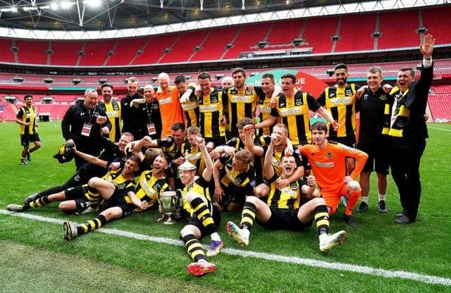 Hebburn Town players and staff celebrate with the Buildbase FA Vase 2019/20 Trophy after the Final at Wembley Stadium, London.