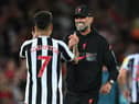 Liverpool's German manager Jurgen Klopp (R) and Liverpool's Brazilian striker Roberto Firmino (L) celebrate on the pitch after the English Premier League football match between Liverpool and Newcastle United at Anfield in Liverpool, north west England on August 31, 2022. - Liverpool won the game 2-1.  (Photo by PAUL ELLIS/AFP via Getty Images)