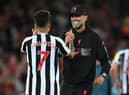 Liverpool's German manager Jurgen Klopp (R) and Liverpool's Brazilian striker Roberto Firmino (L) celebrate on the pitch after the English Premier League football match between Liverpool and Newcastle United at Anfield in Liverpool, north west England on August 31, 2022. - Liverpool won the game 2-1.  (Photo by PAUL ELLIS/AFP via Getty Images)