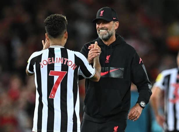 Liverpool's German manager Jurgen Klopp (R) and Liverpool's Brazilian striker Roberto Firmino (L) celebrate on the pitch after the English Premier League football match between Liverpool and Newcastle United at Anfield in Liverpool, north west England on August 31, 2022. - Liverpool won the game 2-1.  (Photo by PAUL ELLIS/AFP via Getty Images)