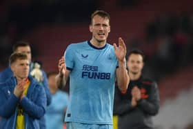Dan Burn applauds Newcastle United fans at the St Mary's Stadium.