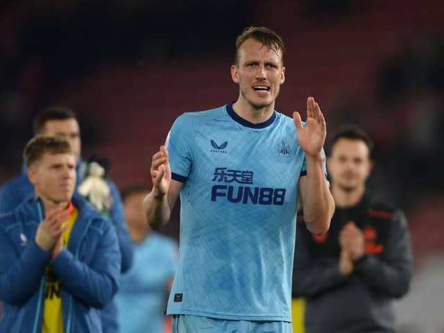 Dan Burn applauds Newcastle United fans at the St Mary's Stadium.
