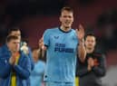 Dan Burn applauds Newcastle United fans at the St Mary's Stadium.