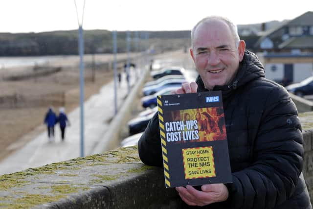 South Tyneside Cllr Ernest Gibson with new Covid signage at the Walkway, Sandhaven, South Shields.