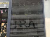 Vandals spray painted the letters "IRA" onto the shop's shutter over the weekend.