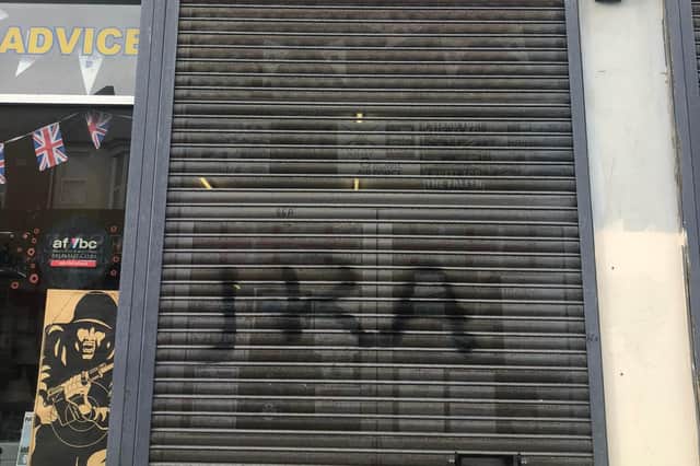 Vandals spray painted the letters "IRA" onto the shop's shutter over the weekend.