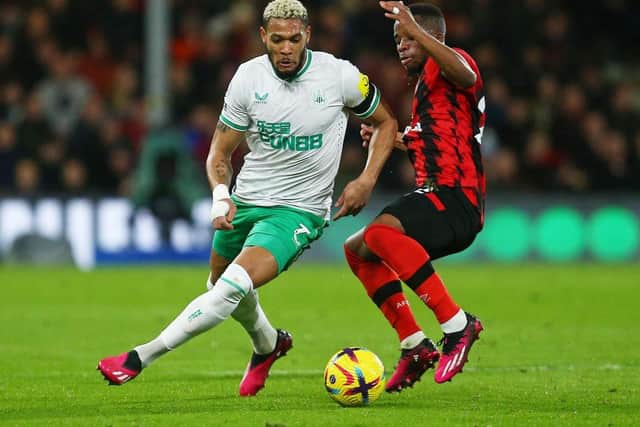 Joelinton of Newcastle United is challenged by Hamed Junior Traore of AFC Bournemouth during the Premier League match between AFC Bournemouth and Newcastle United at Vitality Stadium on February 11, 2023 in Bournemouth, England. (Photo by Charlie Crowhurst/Getty Images)