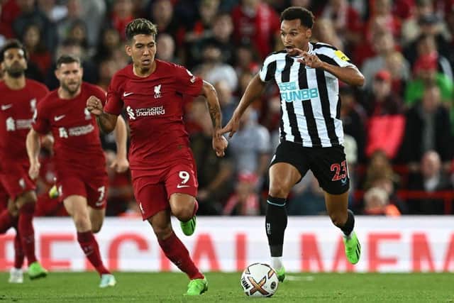 Newcastle United's English midfielder Jacob Murphy (R) vies with Liverpool's Brazilian striker Roberto Firmino (C) during the English Premier League football match between Liverpool and Newcastle United at Anfield in Liverpool, north west England on August 31, 2022. (Photo by PAUL ELLIS/AFP via Getty Images)