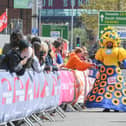 Colin Burgin-Plews dressed in a giant sunflower dress as he approaches the finish line.
