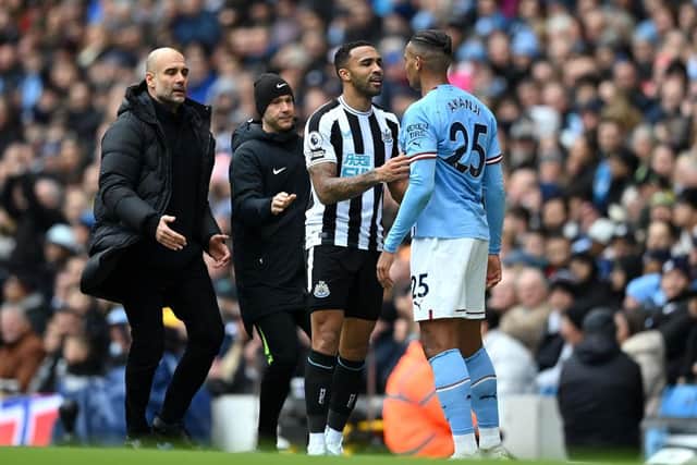 Pep Guardiola, manager of Manchester City, attempts to break up a clash between Newcastle United's Callum Wilson and Manuel Akanji.