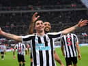 Miguel Almiron of Newcastle United celebrates after scoring their side's fourth goal with Callum Wilson during the Premier League match between Newcastle United and Aston Villa at St. James Park on October 29, 2022 in Newcastle upon Tyne, England. (Photo by Stu Forster/Getty Images)
