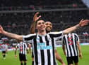 Miguel Almiron of Newcastle United celebrates after scoring their side's fourth goal with Callum Wilson during the Premier League match between Newcastle United and Aston Villa at St. James Park on October 29, 2022 in Newcastle upon Tyne, England. (Photo by Stu Forster/Getty Images)