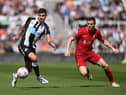Bruno Guimaraes of Newcastle United is challenged by James Milner of Liverpool during the Premier League match between Newcastle United and Liverpool at St. James Park on April 30, 2022 in Newcastle upon Tyne, England. (Photo by Stu Forster/Getty Images)