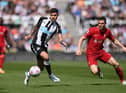 Bruno Guimaraes of Newcastle United is challenged by James Milner of Liverpool during the Premier League match between Newcastle United and Liverpool at St. James Park on April 30, 2022 in Newcastle upon Tyne, England. (Photo by Stu Forster/Getty Images)