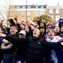 Fans react after first hearing Chelsea was preparing to withdraw from the Super League, outside Stamford Bridge, London.