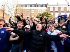 Fans react after first hearing Chelsea was preparing to withdraw from the Super League, outside Stamford Bridge, London.
