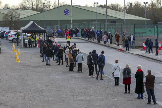 People queue at a Coronavirus testing centre at the Liverpool Tennis Centre in Wavertree, part of the mass Covid-19 testing in Liverpool. Photo by PA.