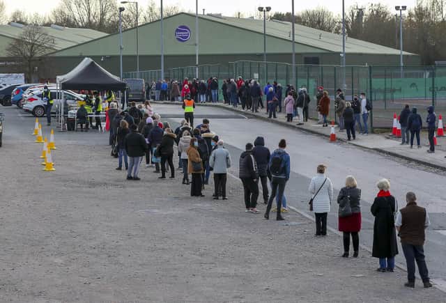 People queue at a Coronavirus testing centre at the Liverpool Tennis Centre in Wavertree, part of the mass Covid-19 testing in Liverpool. Photo by PA.