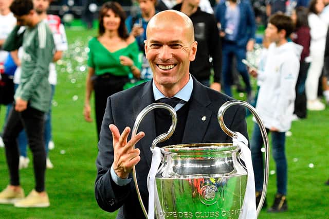 Real Madrid's French coach Zinedine Zidane poses with the trophy after winning  the UEFA Champions League final football match between Liverpool and Real Madrid at the Olympic Stadium in Kiev, Ukraine, on May 26, 2018. (Photo by GENYA SAVILOV / AFP)