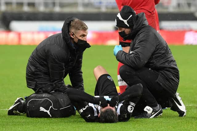 Fabian Schar receives treatment before being stretchered off.