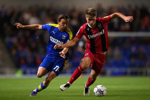 Jack Tucker of Gillingham holds off Ethan Chislett of AFC Wimbledon during the Sky Bet League One match between AFC Wimbledon and Gillingham at Plough Lane.