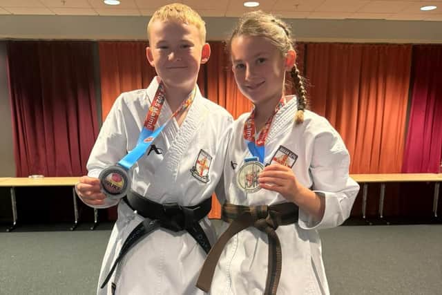 World karate champions Joshua Parkin and Myah Hackett with their medals.