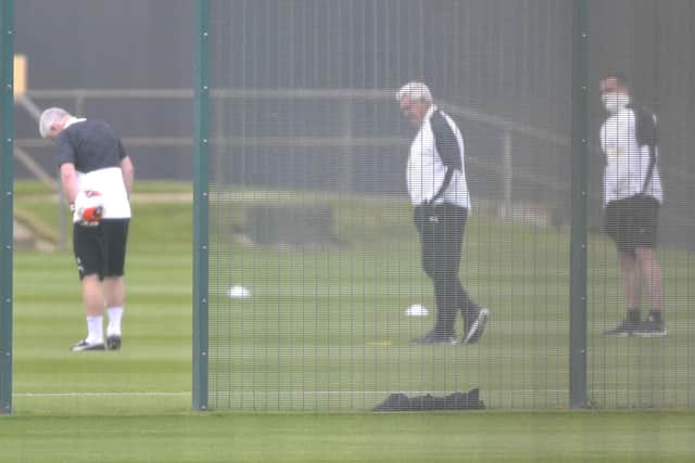 Steve Bruce, centre, and his coaches prepare for training. (Pic: Frank Reid)