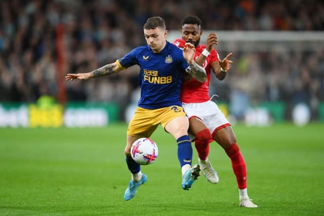 Kieran Trippier of Newcastle United is challenged by Emmanuel Dennis of Nottingham Forest during the Premier League match between Nottingham Forest and Newcastle United at City Ground on March 17, 2023 in Nottingham, England. (Photo by Shaun Botterill/Getty Images)